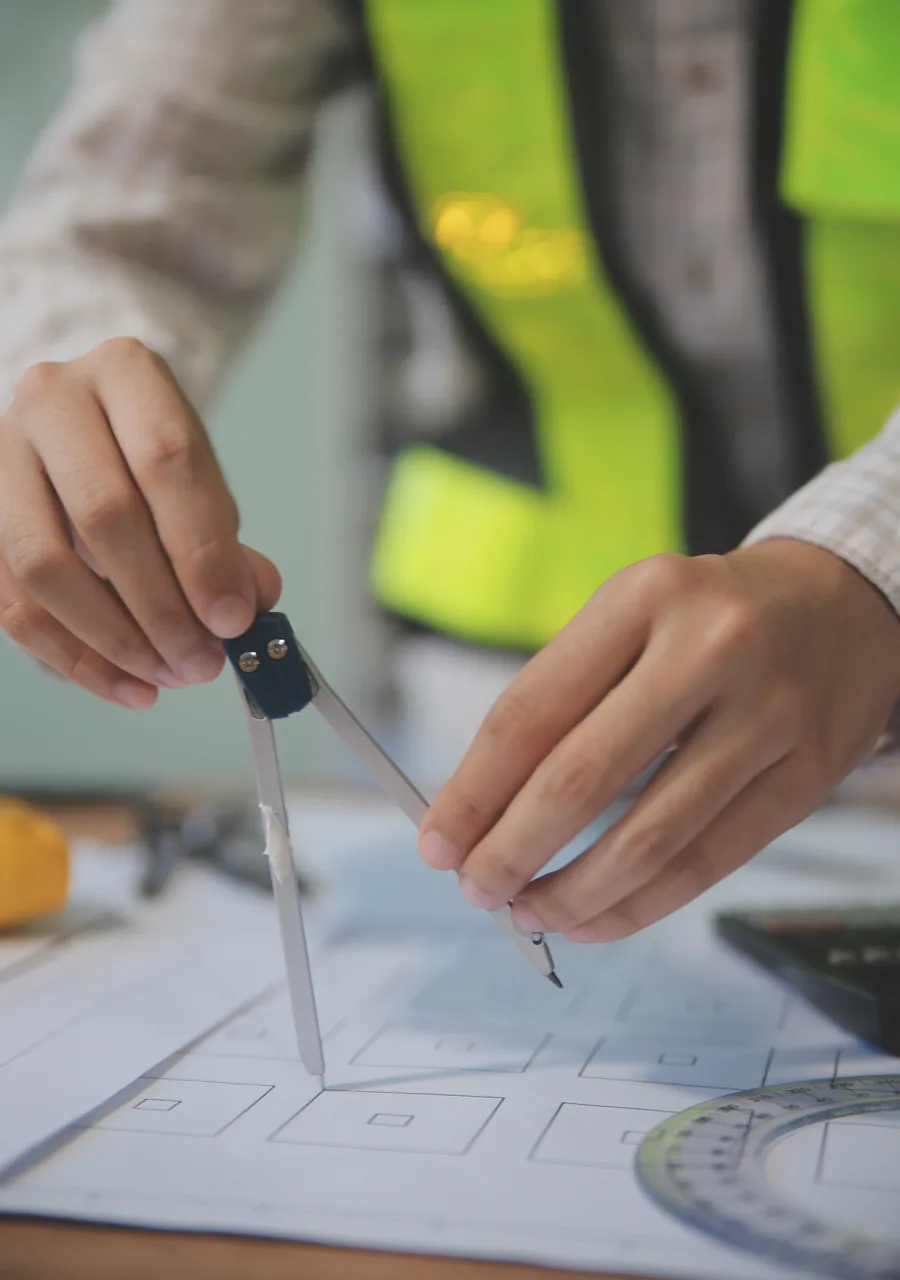 Property specialist measuring architectural plans